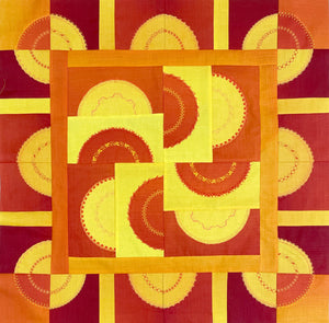 Quilt block using red, yellow, and orange patterns