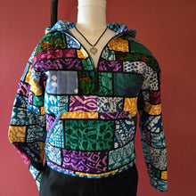 Load image into Gallery viewer, Multicolored patterned jacket on a mannequin against a red background
