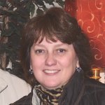 Load image into Gallery viewer, Person wearing a patterned scarf in front of a colorful background

