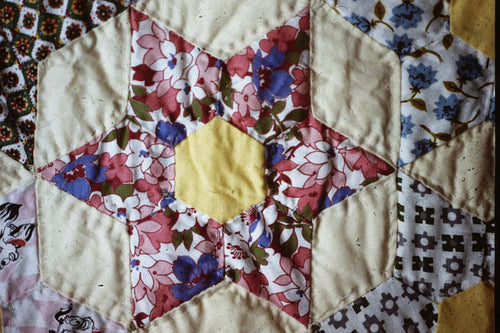 worn looking quilt with a star pattern
